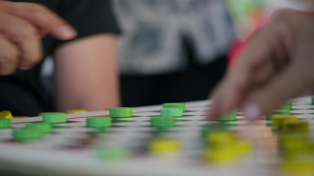 Men Playing Draughts In The Park In Chinatown, Singapore. - close up shot