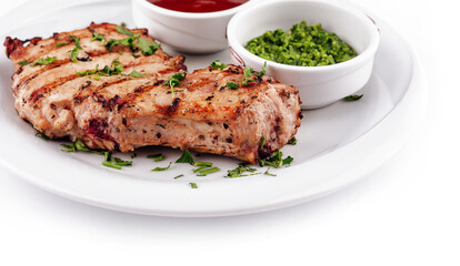 Grilled chicken breast served on plate with sauces