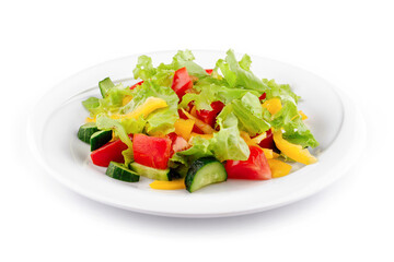 Fresh salad with lettuce, tomatoes, cucumbers and peppers on white plate