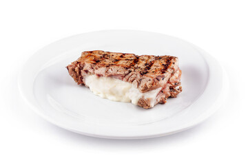 Grilled chicken breast stuffed with cream cheese resting on white plate