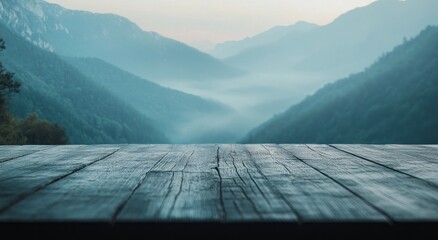 A serene landscape view of misty mountains and a wooden table in the foreground.
