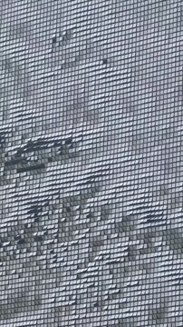 dynamic moving wind driven wall veil. building exterior kinetic metal panels vertical video
