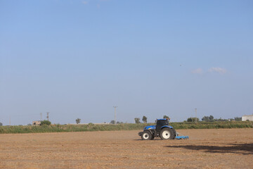 tractor in shredding postharvest residues in the  field
