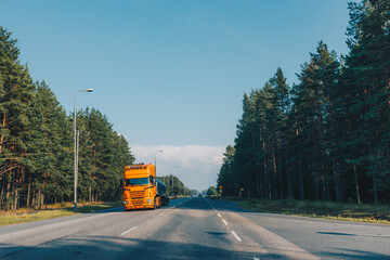 Obraz premium Fuel tanker semi-truck driving on the highway asphalt road in summer Finland