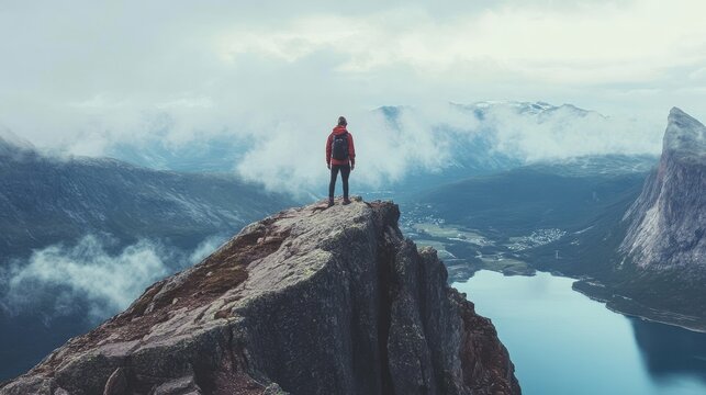 Hike to Husfjellet peak in Norway and conquer the mountain cliff summit to experience adventure, outdoor activity, and a healthy lifestyle.