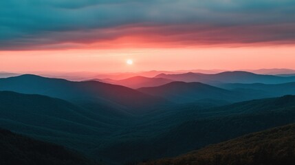 Obraz premium A serene sunset over rolling mountains, casting a warm glow on the landscape.