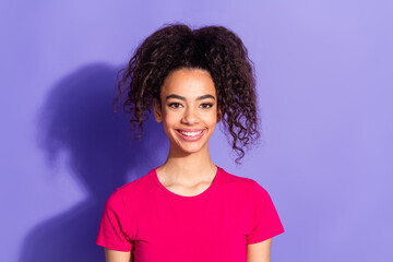 Photo of cheerful pretty lady dressed pink t-shirt smiling empty space isolated purple color...