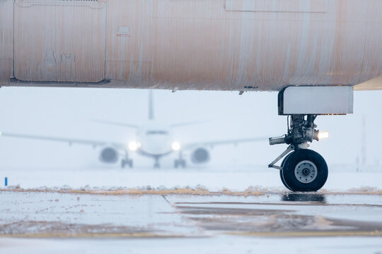 Aircraft fuselage covered with deicing fluid. Deicing of airplane before flight during winter frosty day at airport..