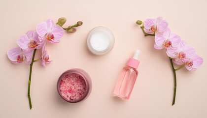 Obraz na płótnie Canvas Top view of orchid flower, cosmetics, creams and make-up. Cosmetics presentation with floral pink background.