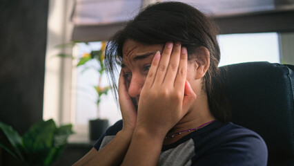Close up of upset African American girl crying, discussing psychological trauma during therapy with psychotherapist. Stressed teenager finds solution on counseling session. Mental health concept.