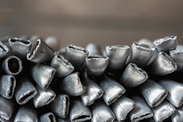 Close-up of aluminum scrap pile at an industrial junkyard shows broken, twisted metal ready for...