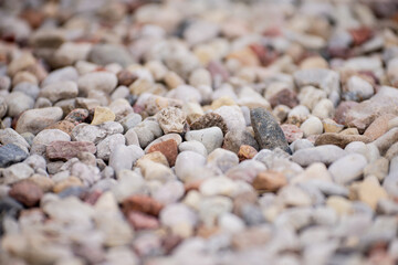 Bright stone pebbles close up on a river bed formation