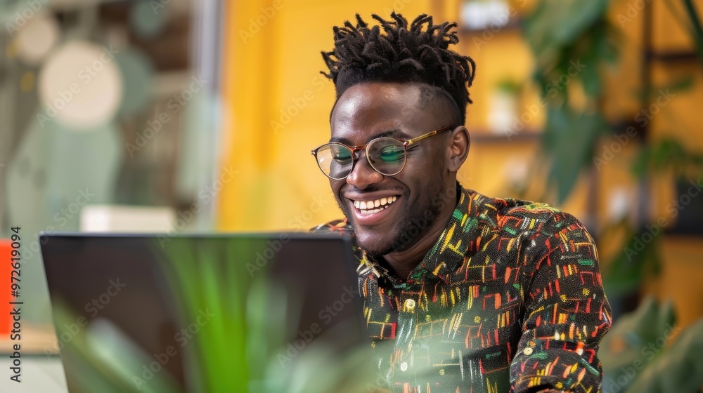 Aufkleber a man with glasses is smiling while using a laptop