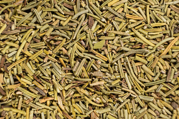 Background macro dried rosemary leaves top view, seasoning texture.