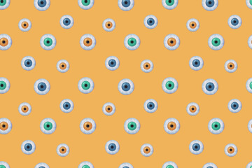 Seamless pattern. Halloween eyes on the yellow background