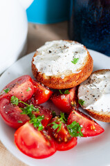 Healthy Breakfast tomato salad, muffins with cream cheese and herbs