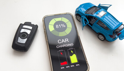 Mobile phone displaying Electric Car EV battery charging station charging in car port, efficient...