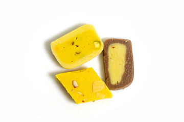 Various Indian sweets during a festive event on a white surface.