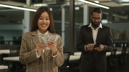 Unequal salary payment problem inequality wage Asian happy woman rich business girl businesswoman hold big money female office sad Indian Arabian businessman man male guy counting little finance