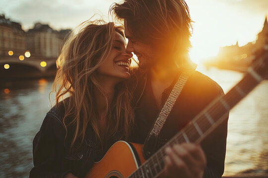 A romantic couple cuddling and playing guitar by a riverside at sunset, dressed casually with the warm sun setting in the background.