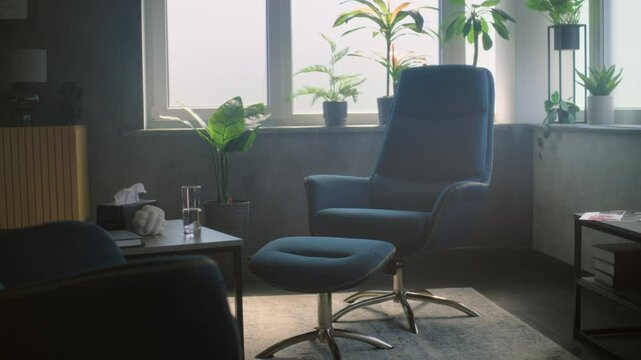 Modern psychological office with stylish interior. Cozy and comfortable space for therapy sessions and consultations with green house plants, two chairs and table. Psychology and mental health.