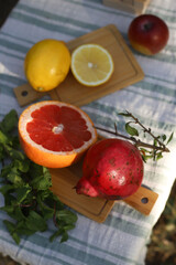 citrus fruits lemon and grapefruit on the table and pomegranate next to it