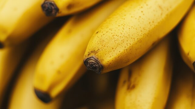 A close-up of a bunch of ripe bananas, showcasing their yellow skin and healthy