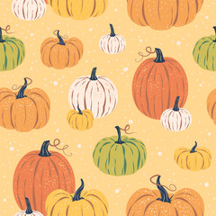 Seamless pattern of colorful pumpkins and spots on yellow background.. Vector illustration in a flat style. Halloween, Thanksgiving, harvest, autumn season fabric, packaging, wrapping paper, wallpaper