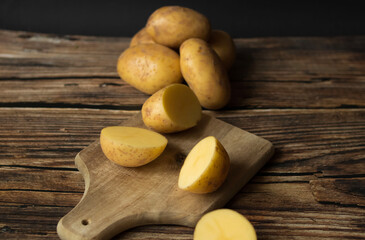 young raw potato. on a dark wooden background. food