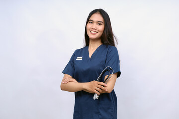 A female nurse is standing wearing scrubs and a stethoscope. He is smiling and looking camera.Portrait of young female nurse isolated on white