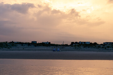 Avalon, New Jersey, USA - The view from the ocean looking at the homes on the coastline with dramatic clouds above them in this beach town on the southern New Jersey