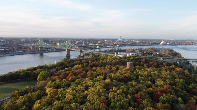 Aerial view of Jean-Drapeau Park, Saint Helen's Island in autumn sunset time. St. Lawrence River, Jacques Cartier Bridge in the background. Montreal, Quebec, Canada.