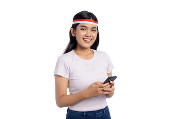 Smiling young Asian woman using smartphone isolated on white background. Indonesian Independence Day Celebration Concept