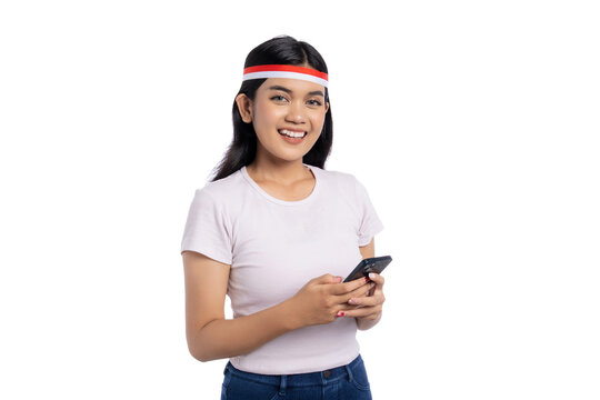 Smiling young Asian woman using smartphone isolated on white background. Indonesian Independence Day Celebration Concept
