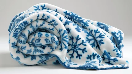 Fotobehang A blue and white blanket with snowflakes on it © vadosloginov