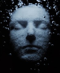 A dark and mysterious 3-D illustration shows a girl underwater with bubbles.