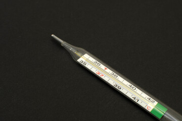 Mercury thermometer on black background