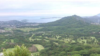 Panoramic footage of the windward side of Honolulu a cloudy day from Nu'uanu Pali Lookout, Hawaii, panning shot