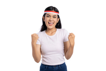 Excited young Asian woman cheering with arms raised isolated on white background. Indonesian Independence Day Celebration Concept