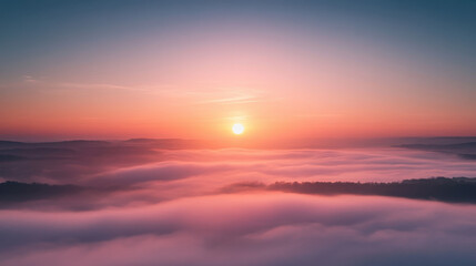 A breathtaking sunrise over a foggy valley, with the sun rising above the mist and the sky painted in soft pastel colors.