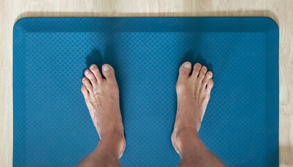 feet on anti fatigue floor mat for standing work