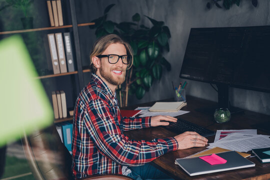 Photo of blond hair cyber security specialist man professional hacker sitting workplace using ips monitor computer and coding sql software