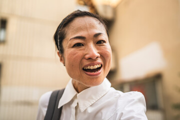 Self portrait of japanese woman stan in front the modern buildings