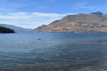 Walking along the Queenstown Gardens by the coastline of Lake Wakatipu on the South Island, New Zealand