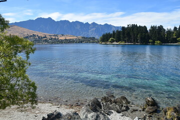 Walking along the Queenstown Gardens by the coastline of Lake Wakatipu on the South Island, New Zealand