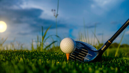 Golf clubs and balls on a green lawn in a beautiful golf course with morning sunshine.