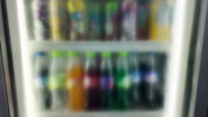 Various beverages in refrigerator with condensation in convenience store