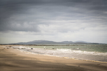 A summer, cloudy HDR image of West Kilbride beach on South Uist with the island of Barra in the background, Outer Hebrides, Scotland.