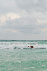 person surfing at the beach in phuket