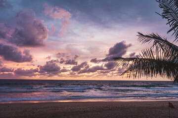 pink and orange sunset with clouds at karong beach in phuket